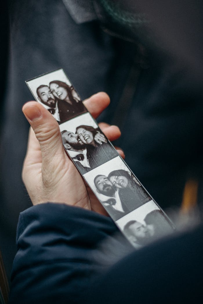 Black and white photo booth strip capturing a couple's joyful moments.